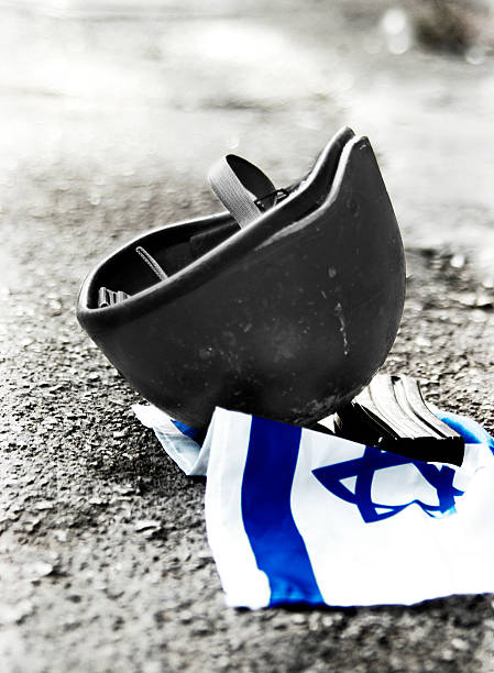 An Israeli flag with a helmet and a M-16 clip on it.